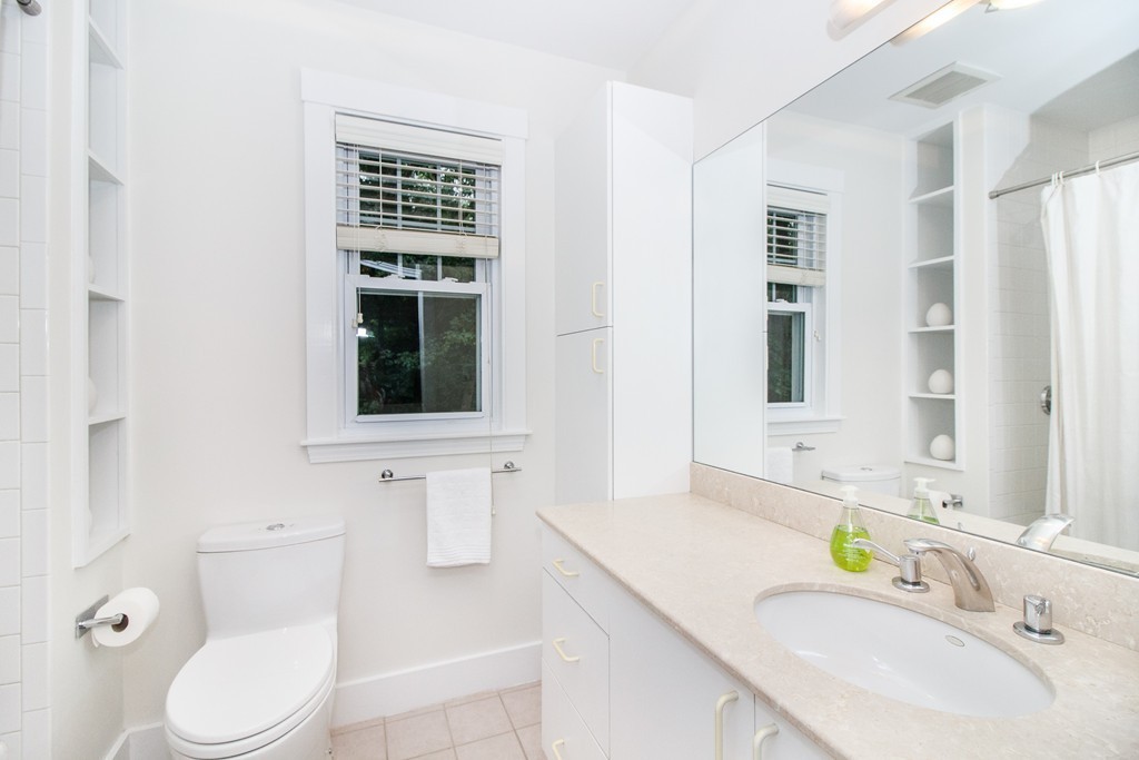 55 Wilde Road Newton, MA 02468 - Photo 19 of 30 a bathroom with a sink a toilet and shower