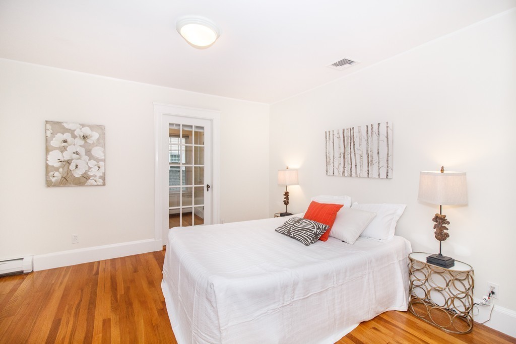 55 Wilde Road Newton, MA 02468 - Photo 22 of 30 a bedroom with a bed and a lamp