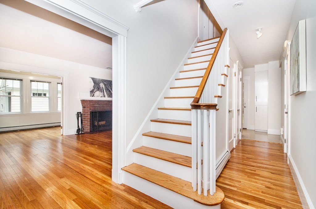 55 Wilde Road Newton, MA 02468 - Photo 3 of 30 a view of a hallway with wooden floor and staircase