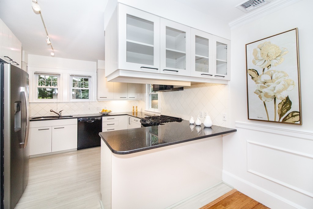 55 Wilde Road Newton, MA 02468 - Photo 7 of 30 a kitchen with stainless steel appliances granite countertop a sink stove and refrigerator