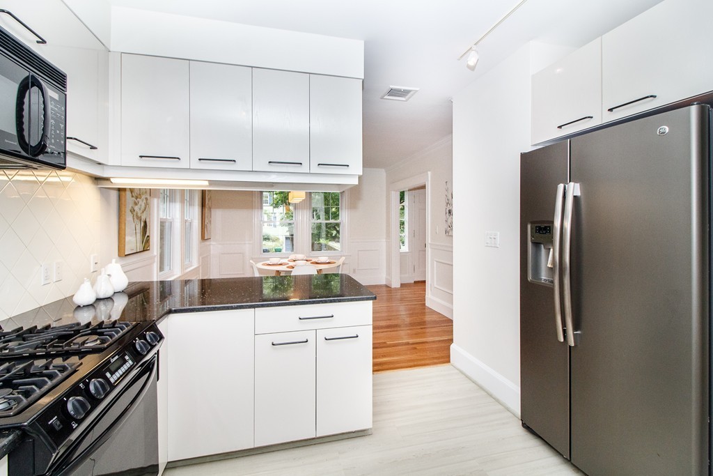 55 Wilde Road Newton, MA 02468 - Photo 8 of 30 a kitchen with stainless steel appliances a sink stove and refrigerator