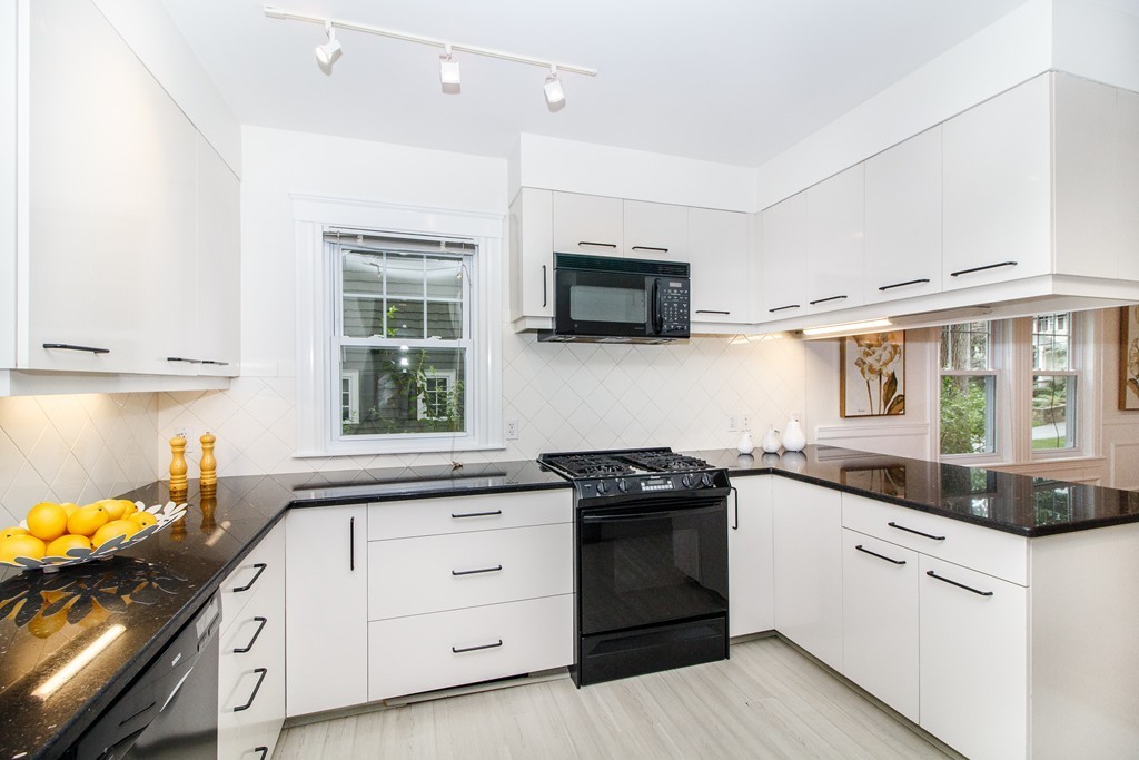 55 Wilde Road Newton, MA 02468 - Photo 9 of 30 a kitchen with stainless steel appliances granite countertop a stove and a sink