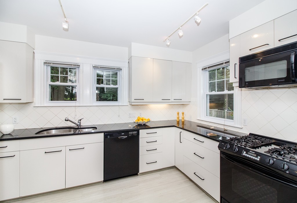 55 Wilde Road Newton, MA 02468 - Photo 10 of 30 a kitchen with stainless steel appliances a sink stove and microwave