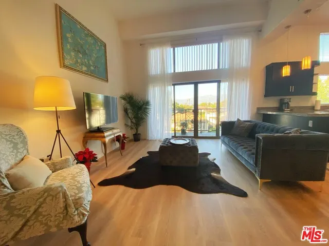 a bedroom with a bed window and a flat screen tv