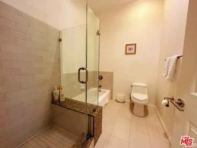 a bathroom with a toilet and shower