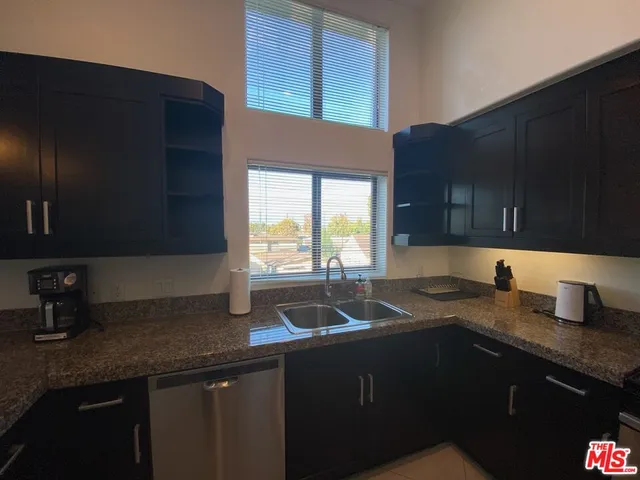 a kitchen with a sink a stove and cabinets
