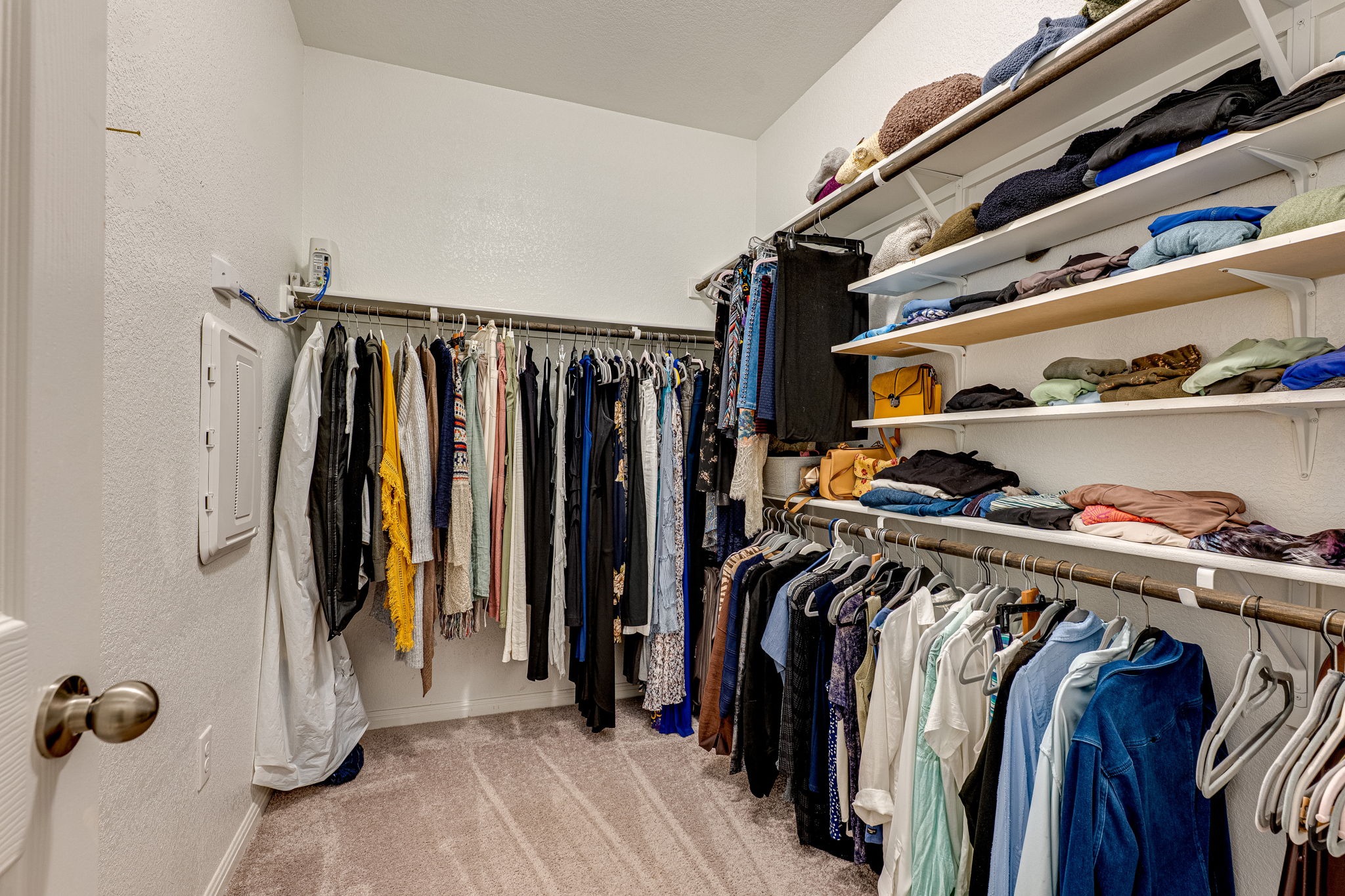 1009 Goldilocks Lane Manchaca, TX 78652 - Photo 23 of 40 Larger of the two walk-in closets in the primary suite, featuring extensive built-in shelving and multiple clothing rods.