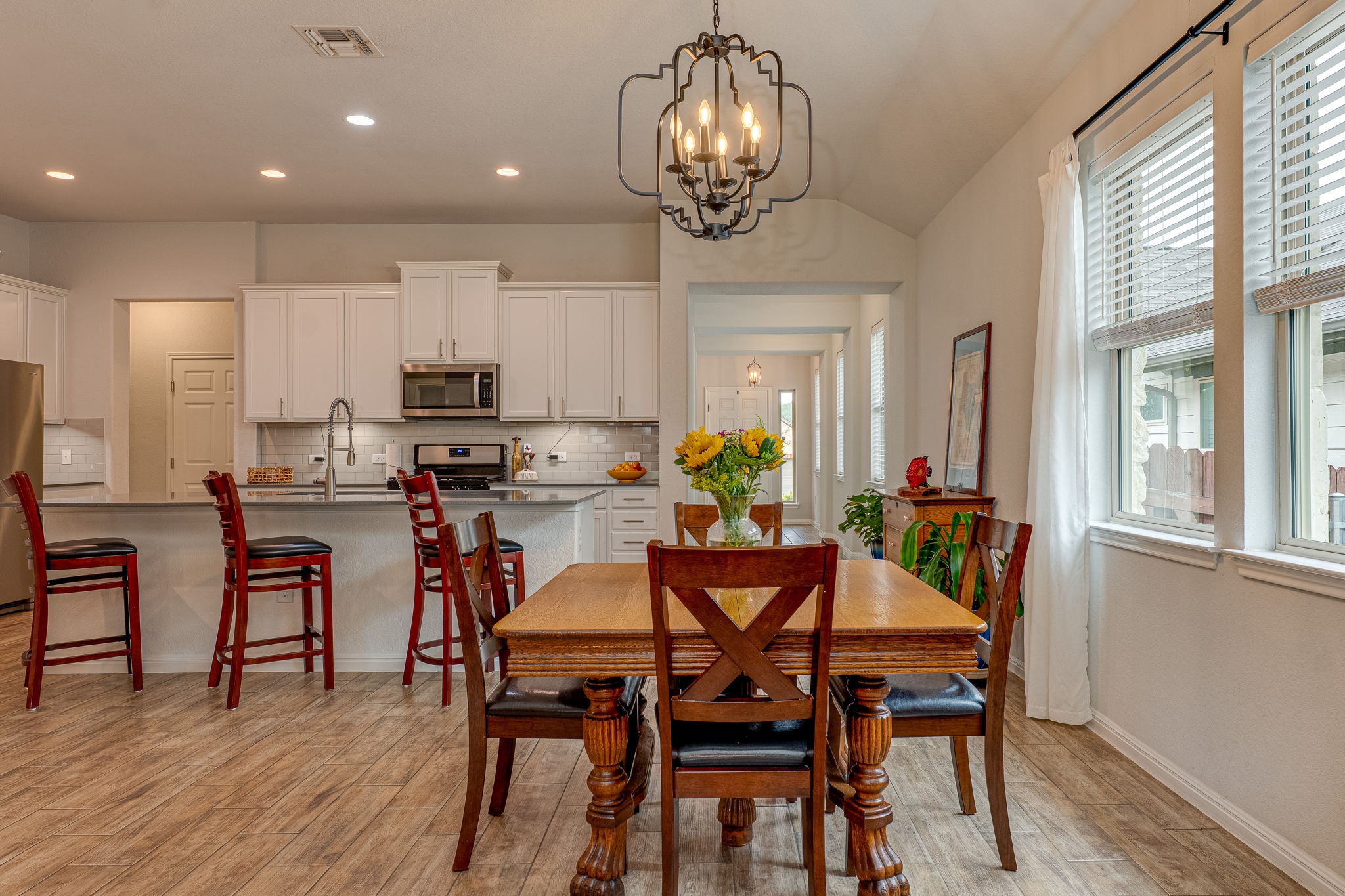 1009 Goldilocks Lane Manchaca, TX 78652 - Photo 10 of 40 Open-concept kitchen and dining area featuring wood-look tile flooring.