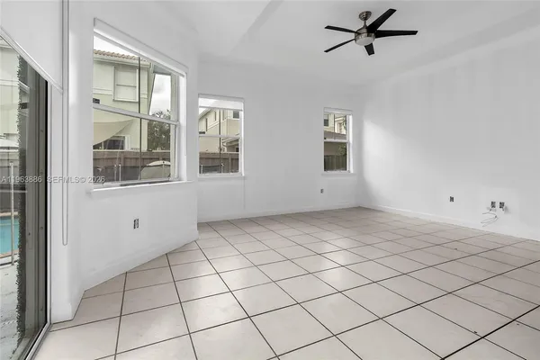 a view of a kitchen with a sink and an empty room