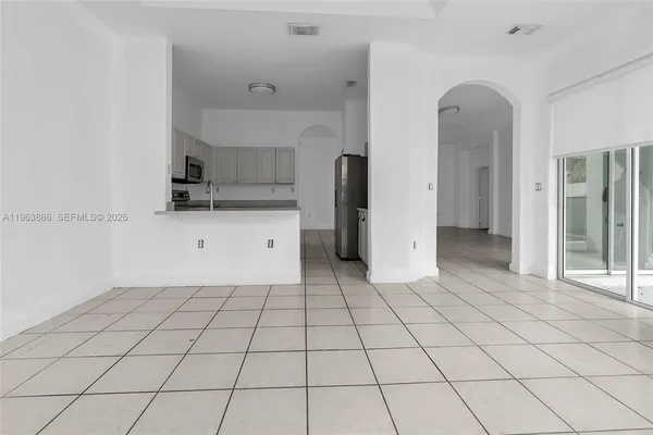 a kitchen with stainless steel appliances a refrigerator sink and microwave