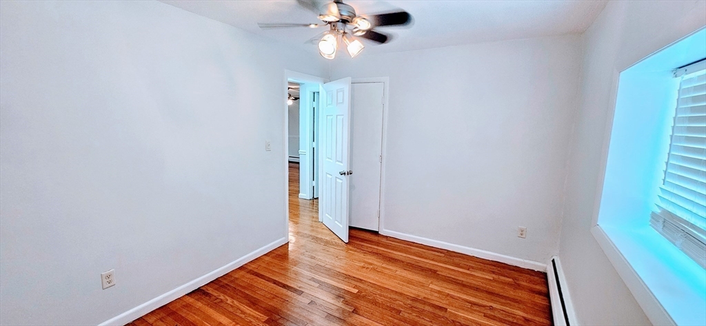 7 Oakcrest Road, Unit 6 Boston, MA 02136 - Photo 9 of 10 a view of empty room with wooden floor and fan