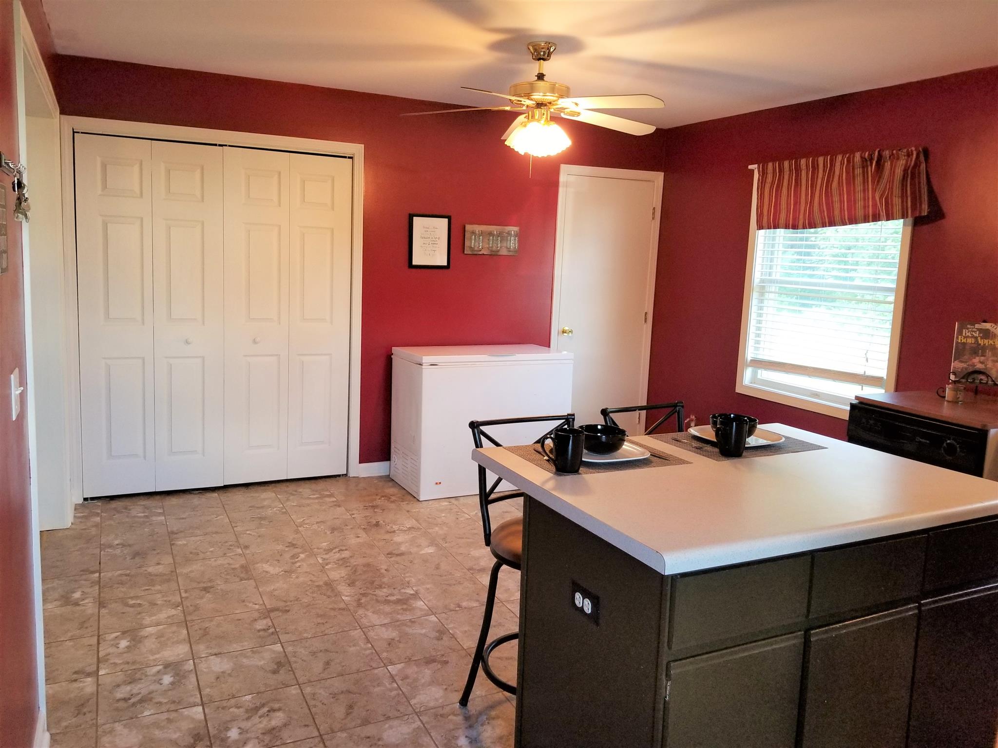 3312 Friendship Road Cross Plains, TN 37049 - Photo 7 of 11 a kitchen with a sink a stove cabinets and a dining table