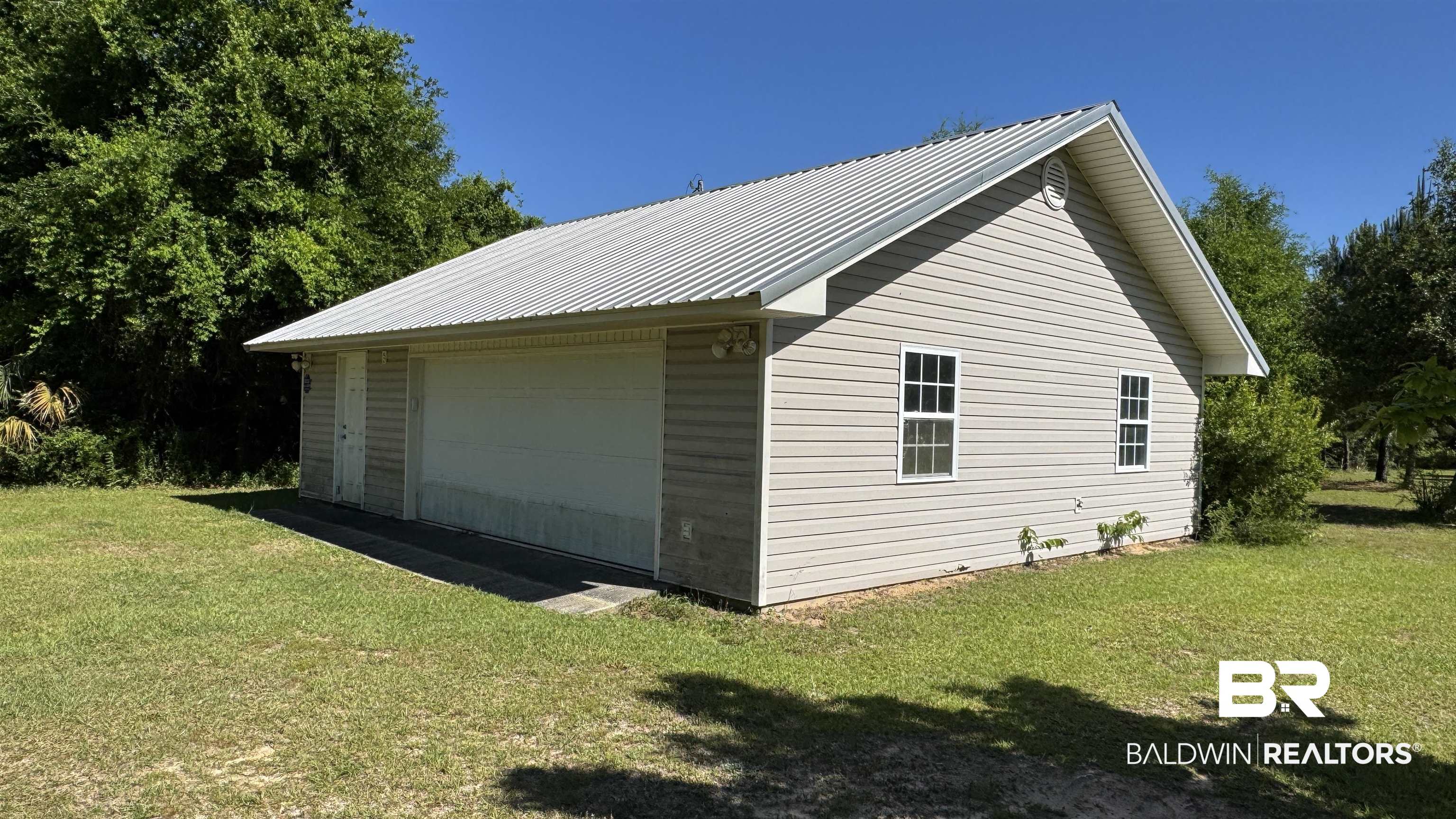 33370 Highway 98 Lillian, AL 36549 - Photo 14 of 58 Detached structure with light-colored siding and a metal roof
