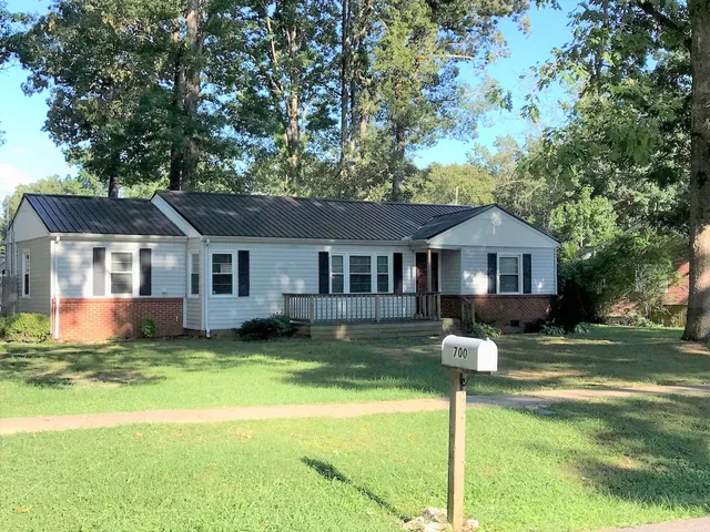 a front view of a house with a yard patio and fire pit