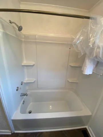 a bathroom with a shower and a bath tub