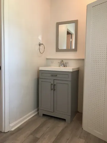 a bathroom with a granite countertop sink mirror and vanity