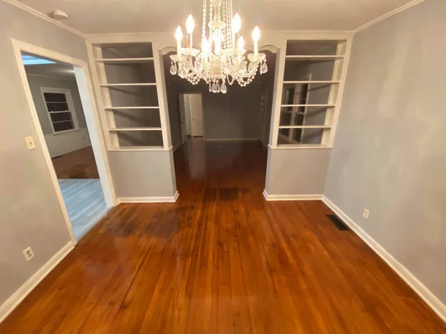 a view of a room with wooden floor and windows