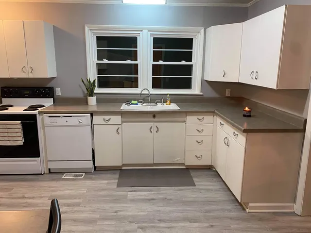 a kitchen with stainless steel appliances granite countertop a stove and a sink