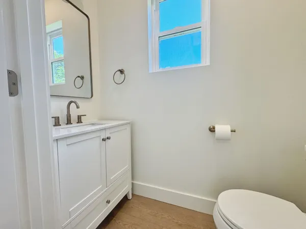 a bathroom with a toilet sink and mirror