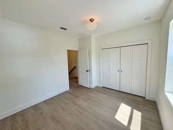a view of an empty room and wooden floor