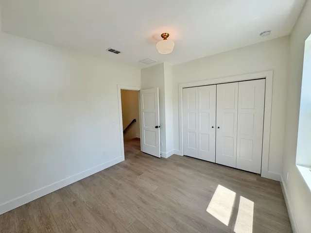 a view of an empty room and wooden floor