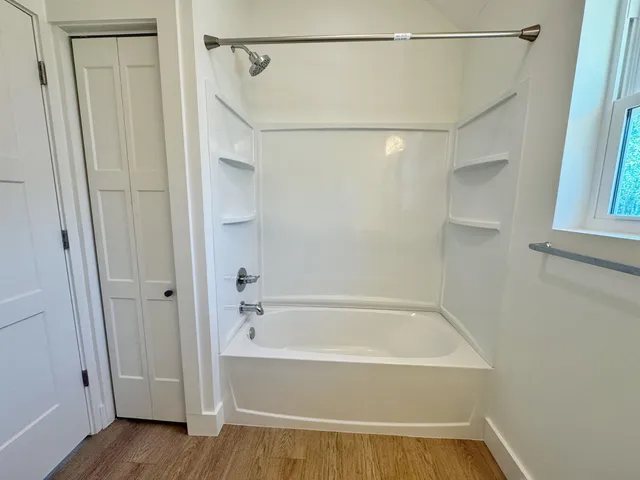 a bathroom with a bathtub and a shower