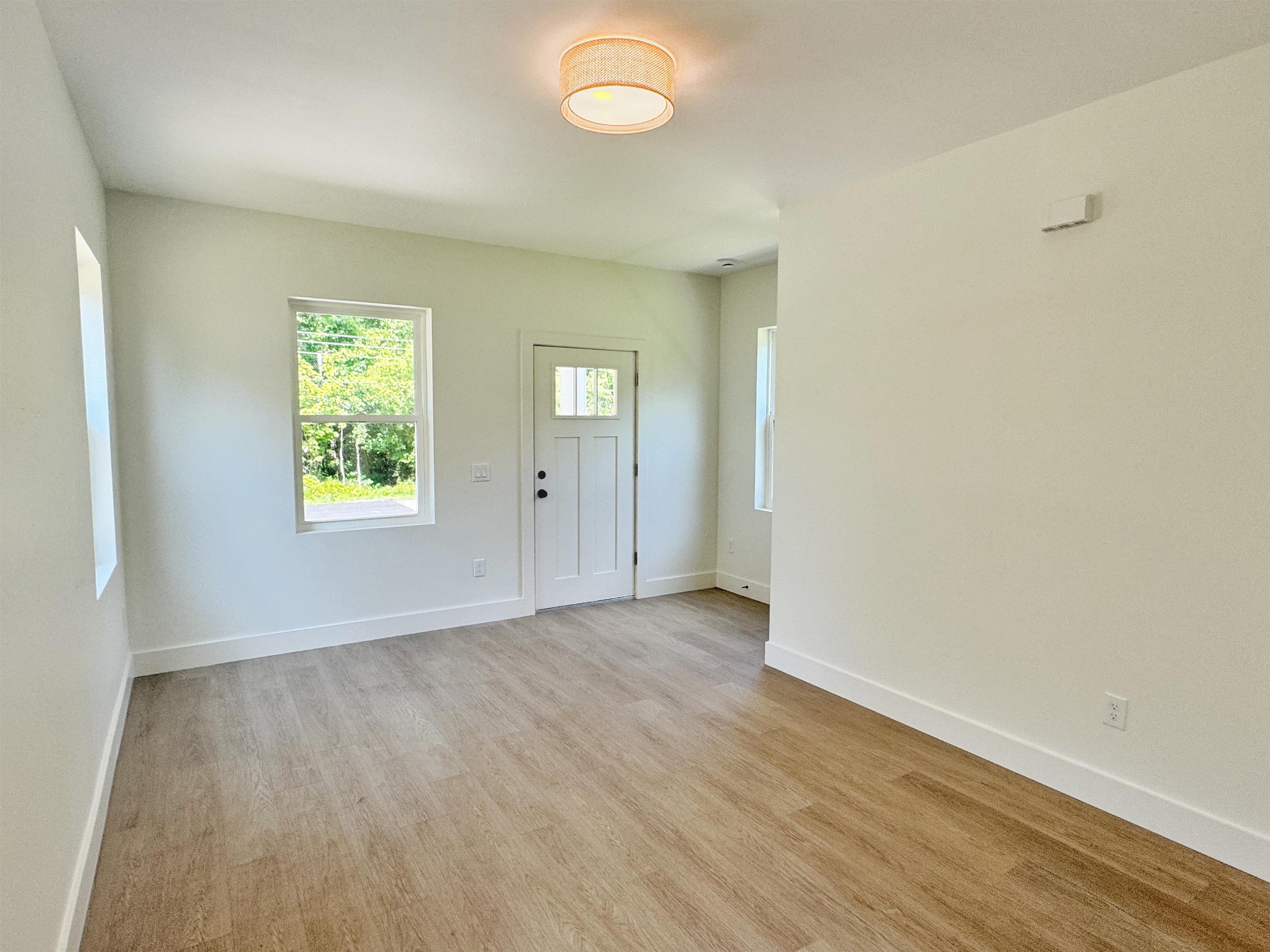 942 Alexander Street St. Augustine, FL 32084 - Photo 5 of 28 an empty room with wooden floor and windows