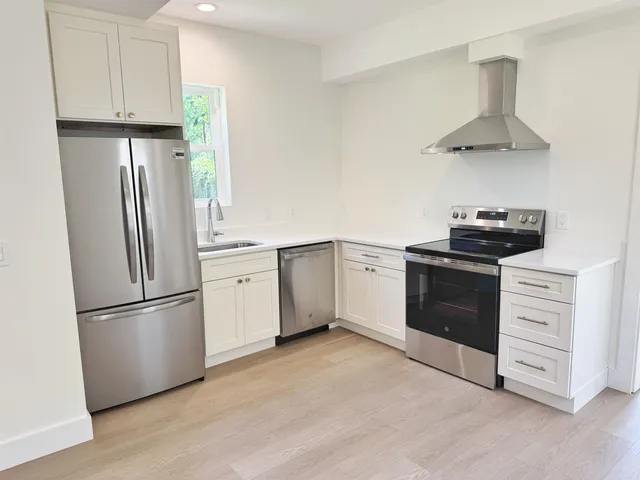 a kitchen with stainless steel appliances a refrigerator sink and stove