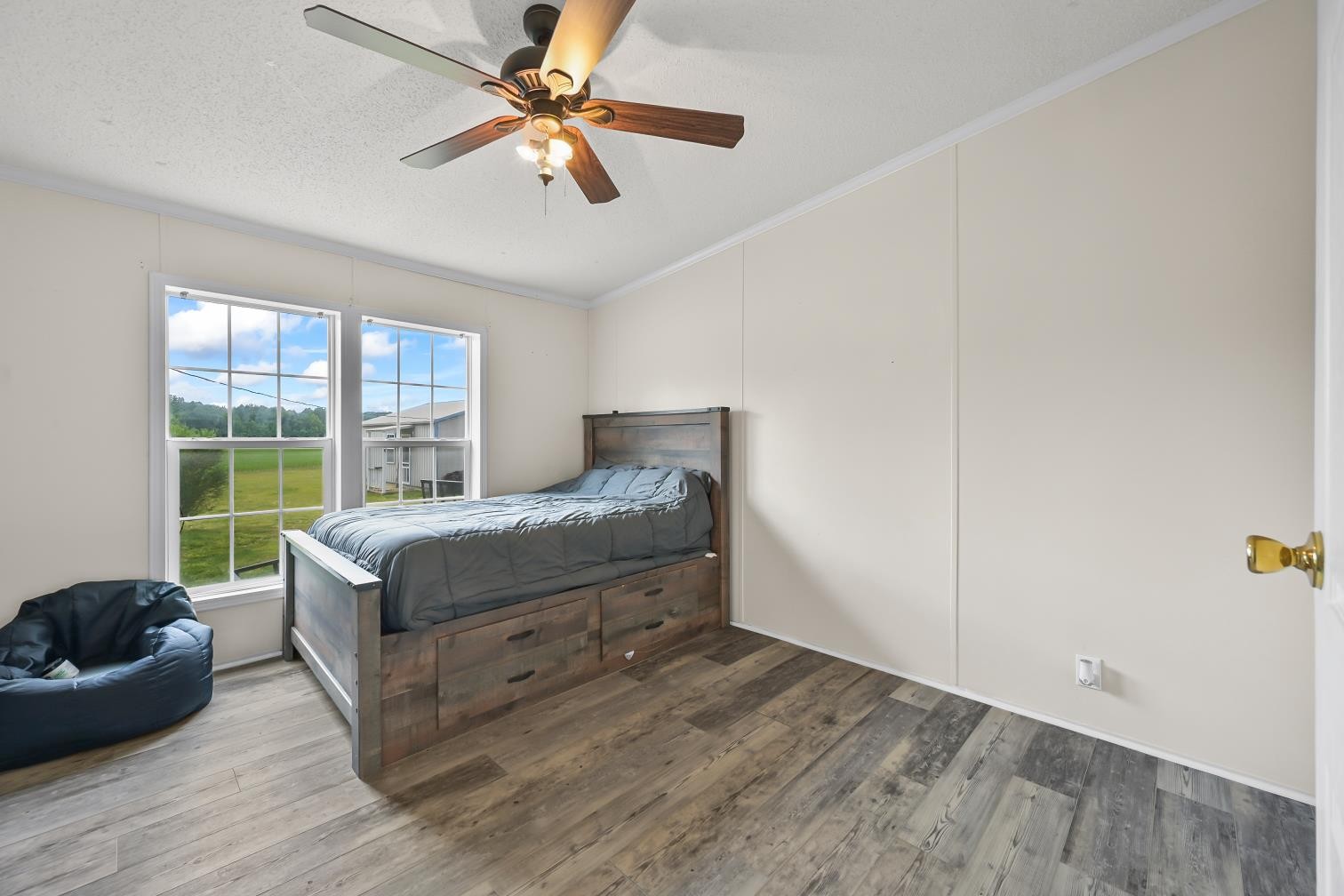 6439 Cedar Grove Road Big Sandy, TN 38221 - Photo 17 of 38 a bedroom with a bed and a chandelier