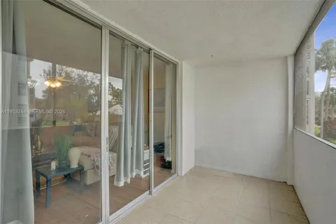 a view of a bathroom with a glass door and a window
