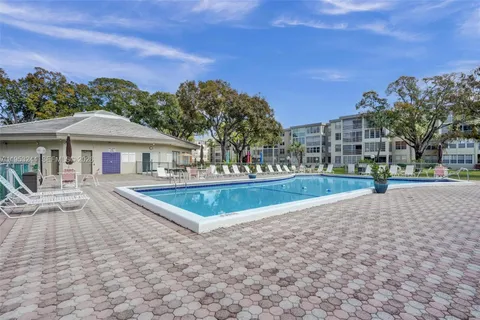 a view of house with yard and swimming pool