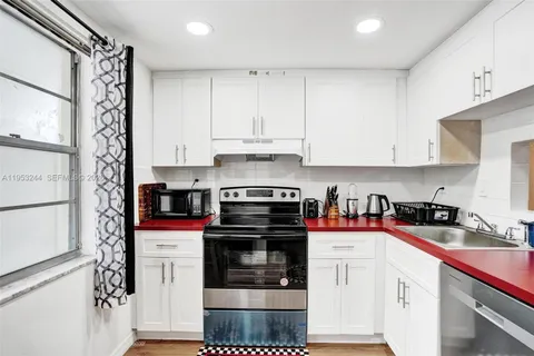 a kitchen with stainless steel appliances granite countertop a stove and a refrigerator