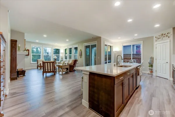 a kitchen with lots of counter top space and view of living room