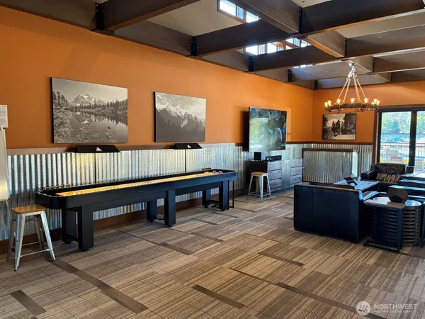 a living room with stainless steel appliances kitchen island granite countertop a table and chairs in it