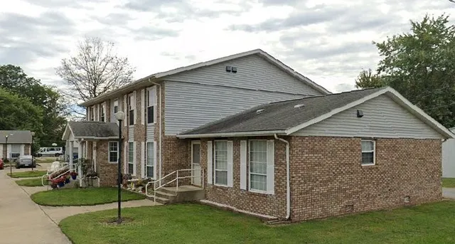 a view of a house with a yard and sitting area