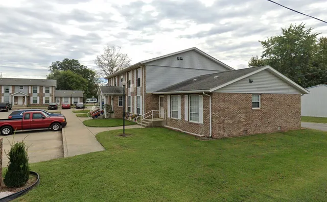 a front view of house with yard and green space