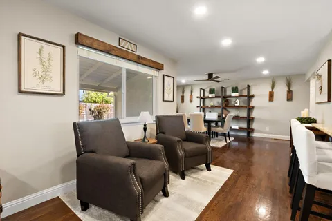 a living room with furniture and wooden floor