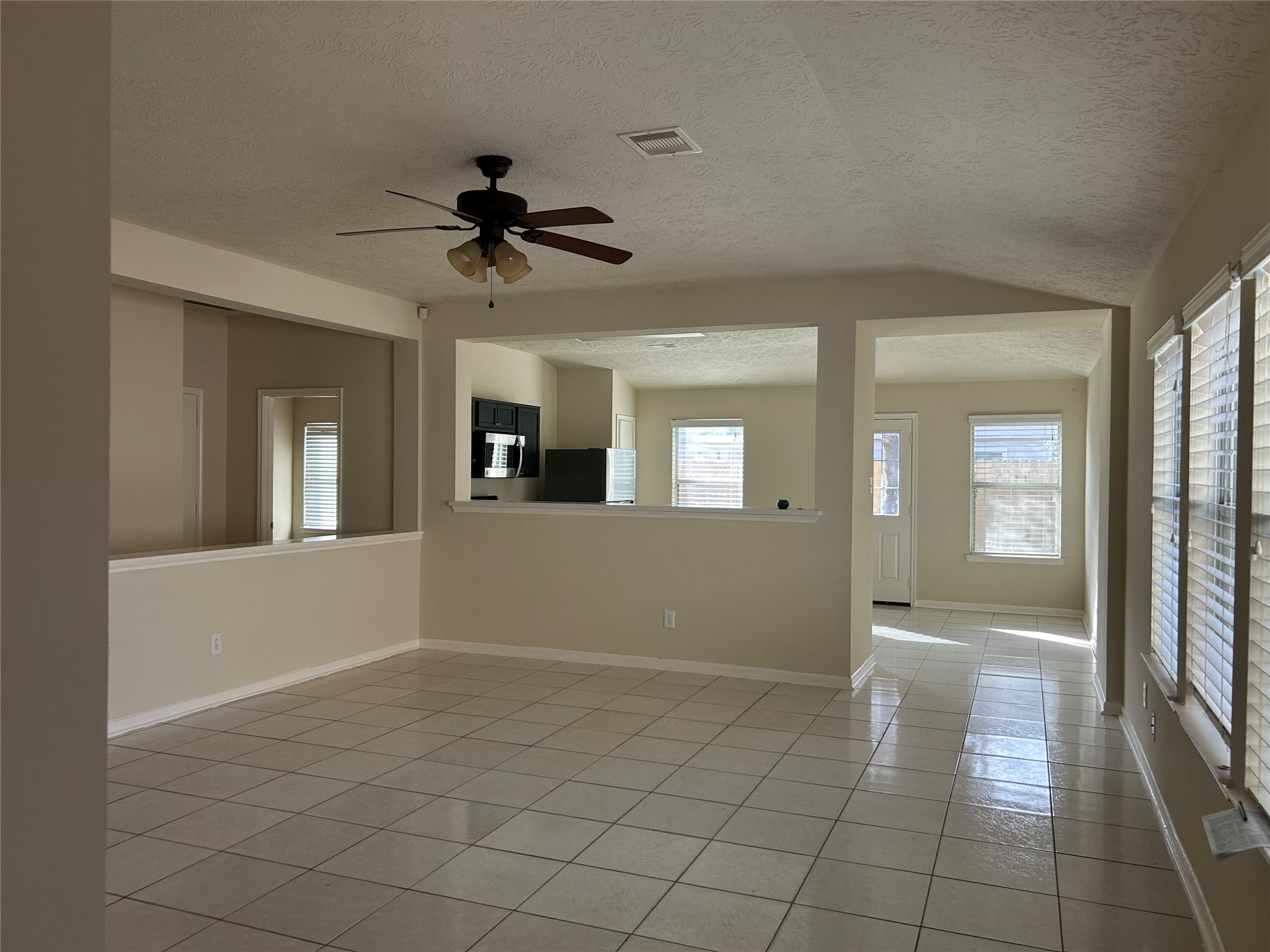11635 Alpine Vale Court Houston, TX 77038 - Photo 4 of 18 a view of a hallway with a chandelier fan and windows