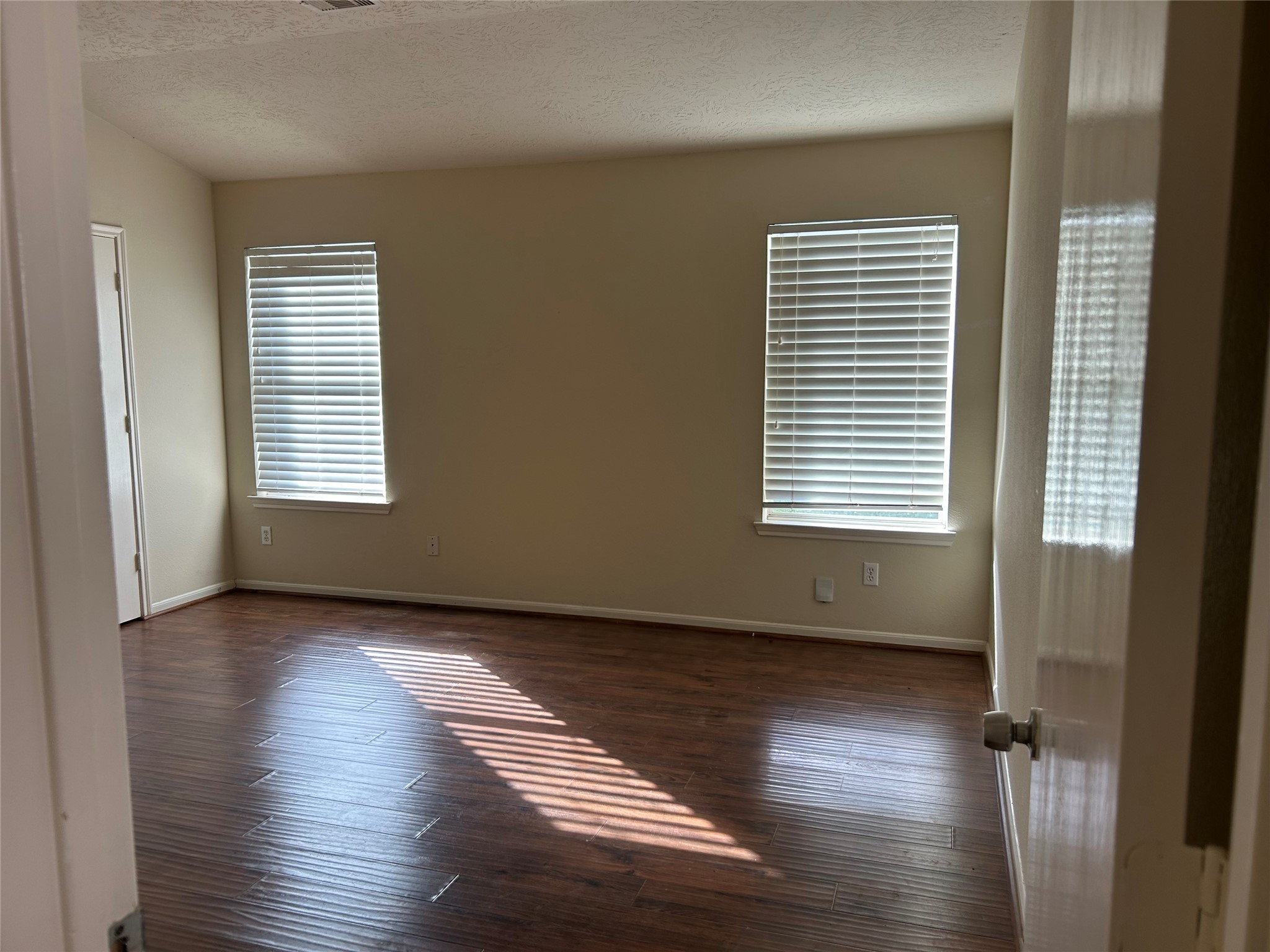 11635 Alpine Vale Court Houston, TX 77038 - Photo 8 of 18 a view of an empty room with wooden floor and a window