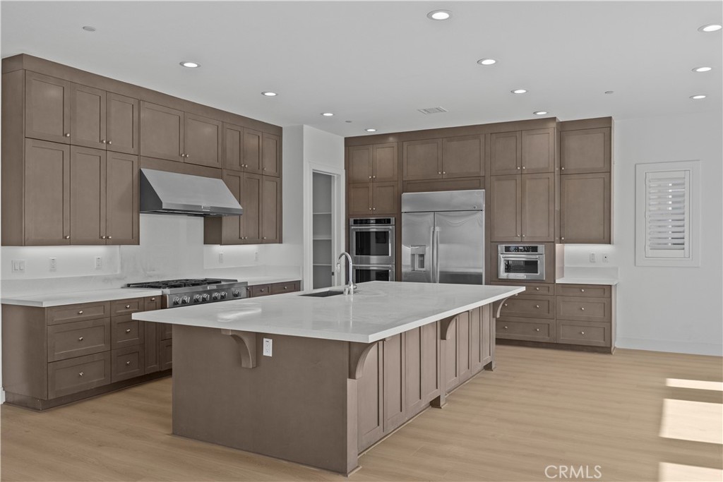 20638 Deer Grass Court Porter Ranch, CA 91326 - Photo 16 of 50 a kitchen with stainless steel appliances granite countertop a stove a sink a refrigerator and a oven