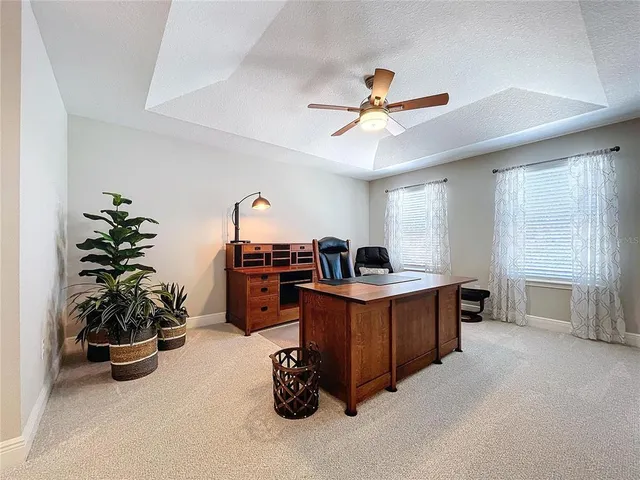 a work room with furniture and potted plant