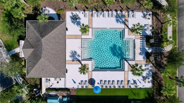 an aerial view of a house with a garden and swimming pool