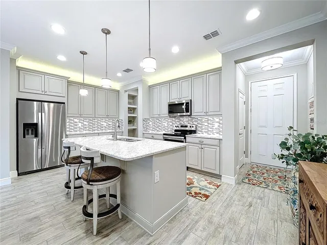 a kitchen with kitchen island a sink a counter and cabinets