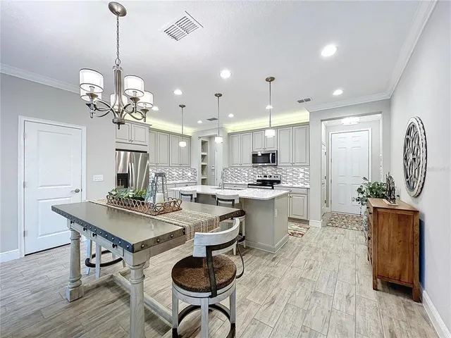 a kitchen with a table and chairs in it