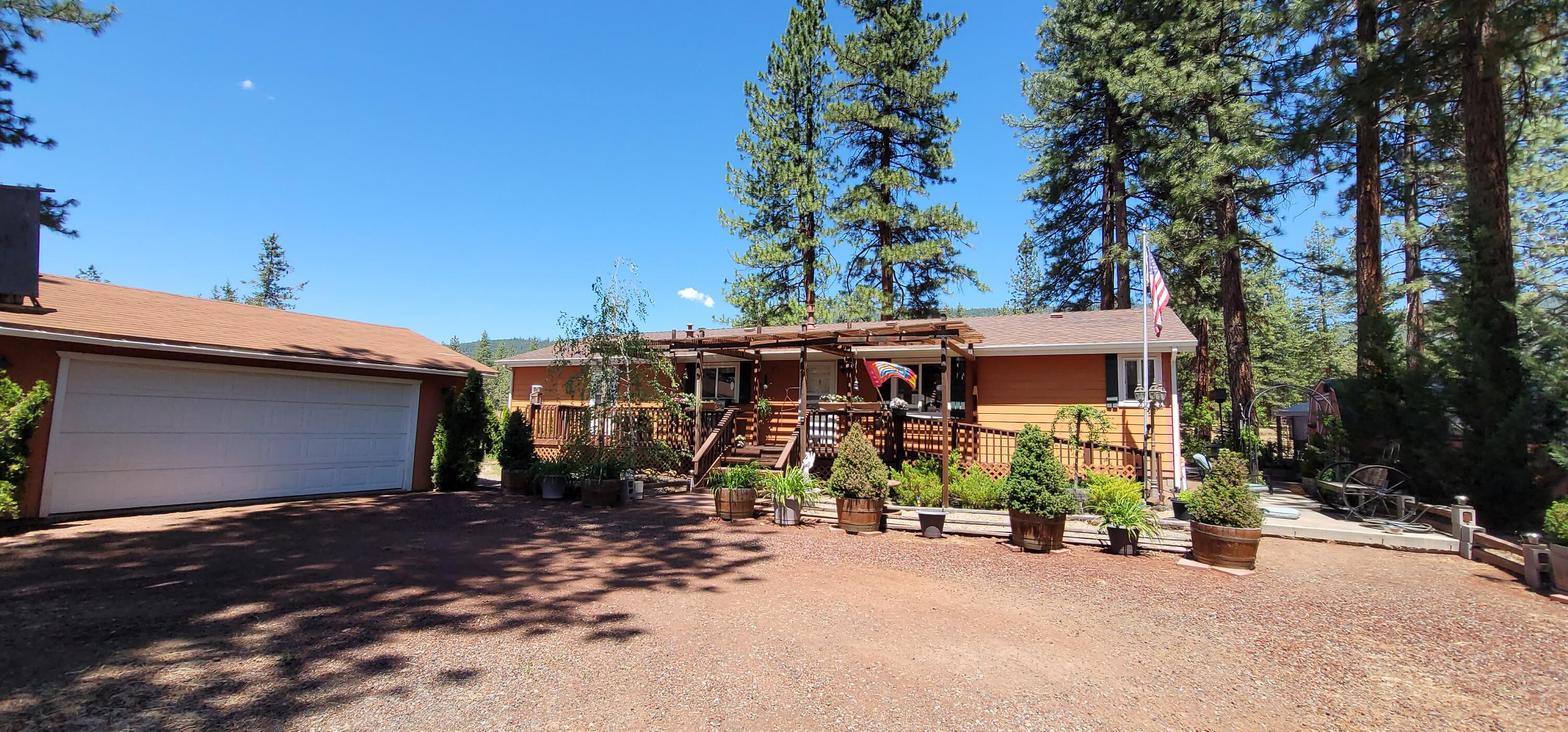 29077 Day Road McArthur, CA 96056 - Photo 2 of 58 a view of a house with potted plants and large trees