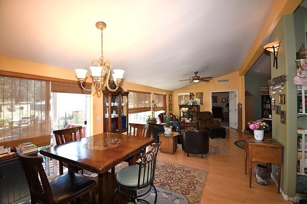29077 Day Road McArthur, CA 96056 - Photo 21 of 58 a view of a dining room and livingroom with furniture wooden floor a chandelier