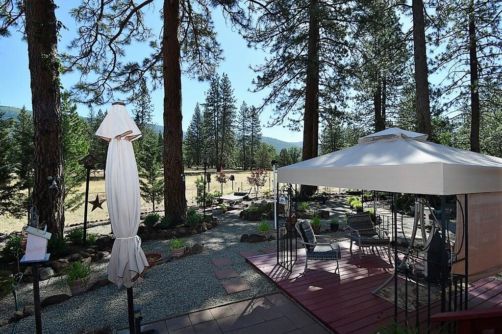29077 Day Road McArthur, CA 96056 - Photo 45 of 58 a view of a patio with table and chairs potted plants and large tree