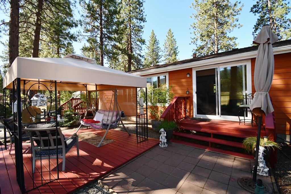 29077 Day Road McArthur, CA 96056 - Photo 7 of 58 a backyard of a house with barbeque oven table and chairs
