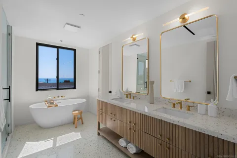 a bathroom with a granite countertop toilet a sink and mirror