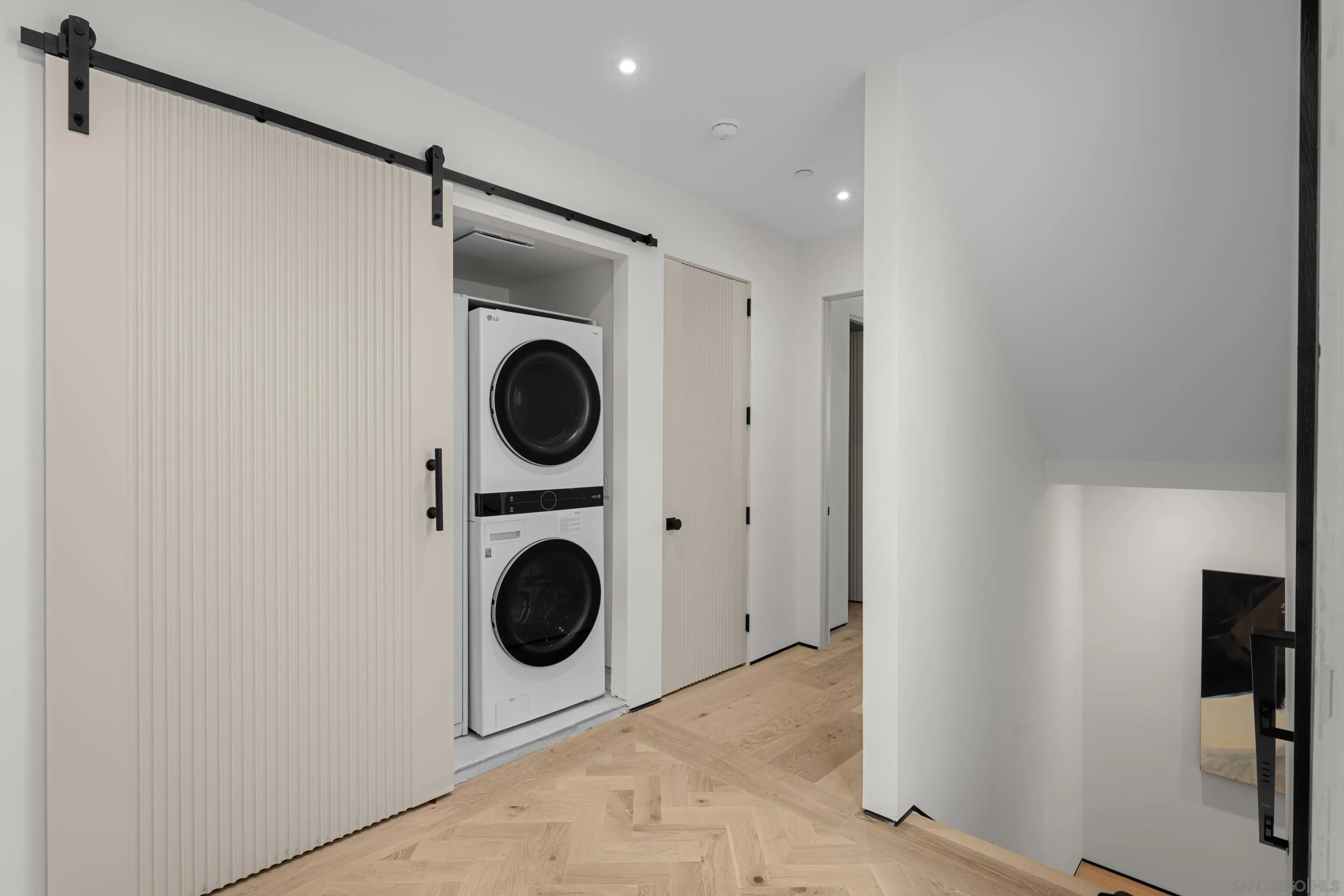 242 Playa Del Norte Street La Jolla, CA 92037 - Photo 21 of 32 a view of a hallway with washer and dryer